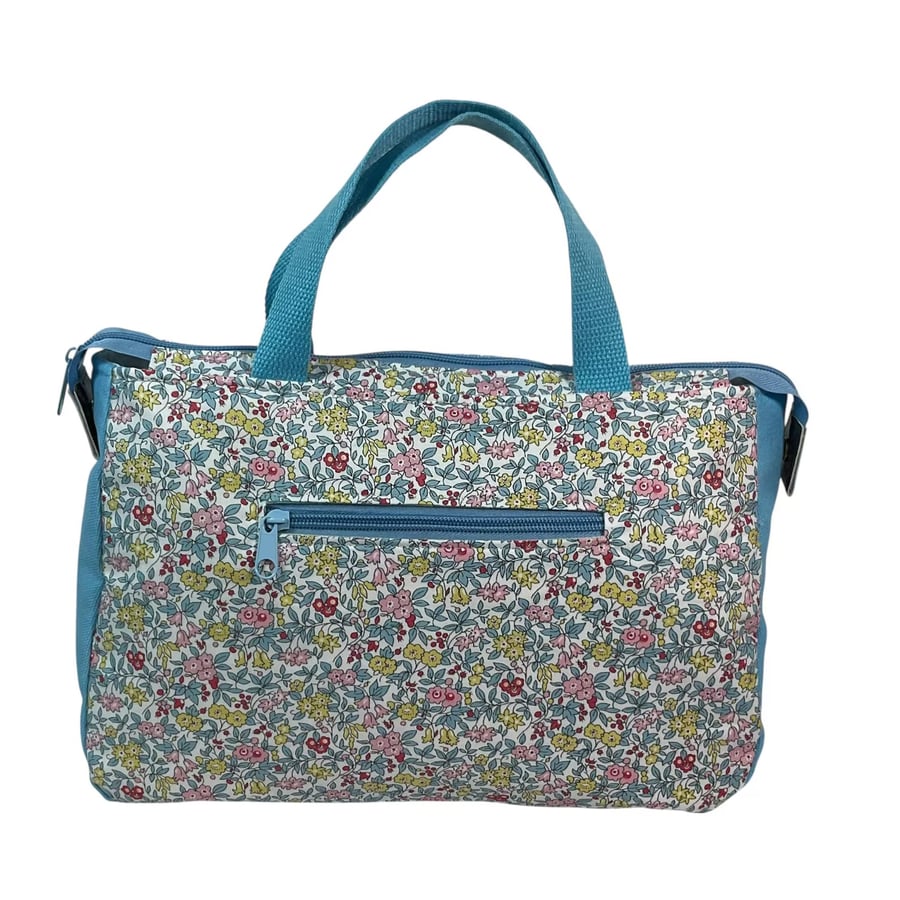 large toiletries bag made from  Liberty fabric, with handles and pockets in and 