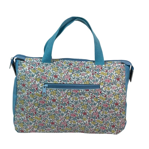 large toiletries bag made from  Liberty fabric, with handles and pockets in and 