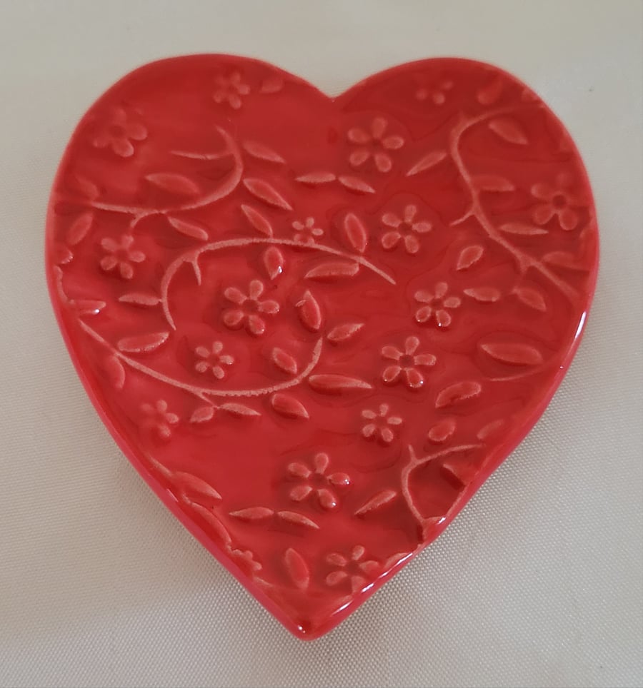 Floral embossed heart ring dish.