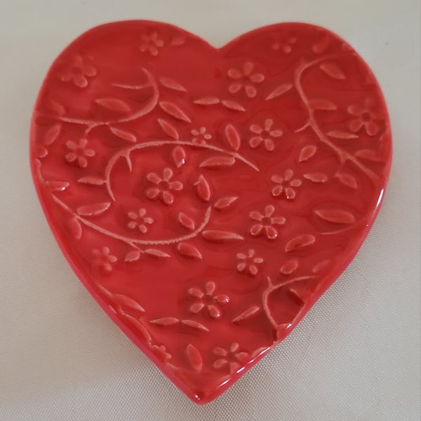 Floral embossed heart ring dish.