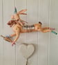Wall mounted leaping hare with carrot textile art