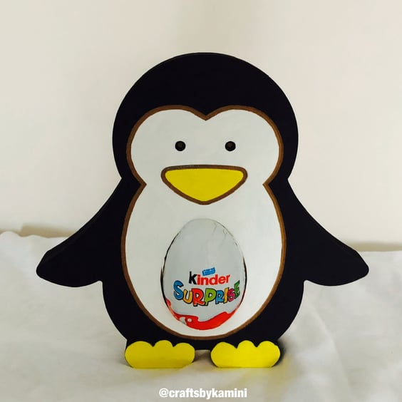 Penguin Holding a Kinder Egg