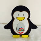 Penguin Holding a Kinder Egg