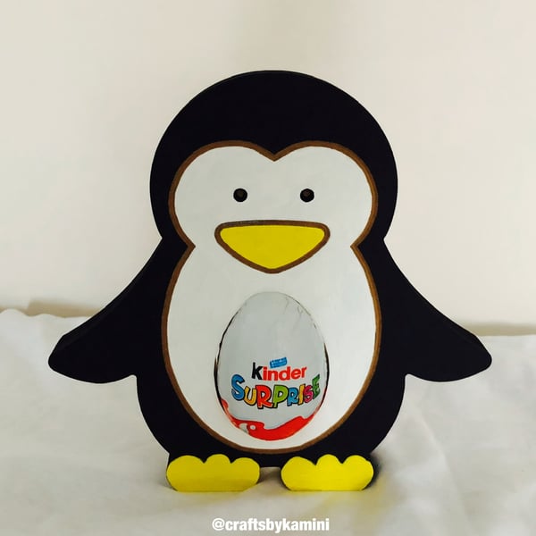 Penguin Holding a Kinder Egg