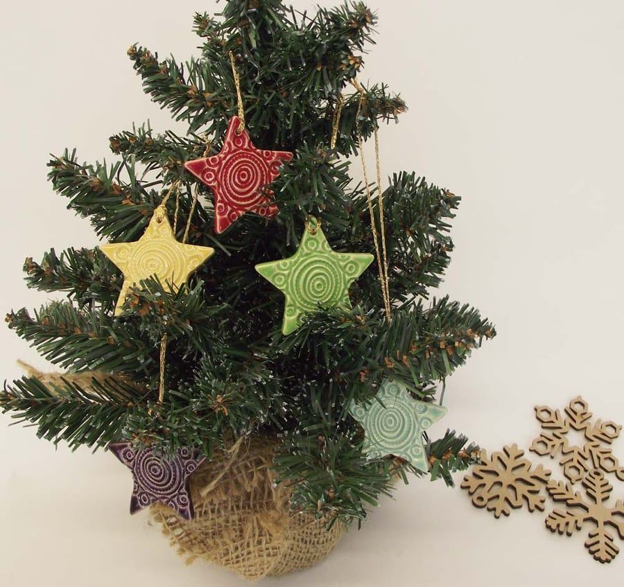 Set of five little handmade ceramic star decorations
