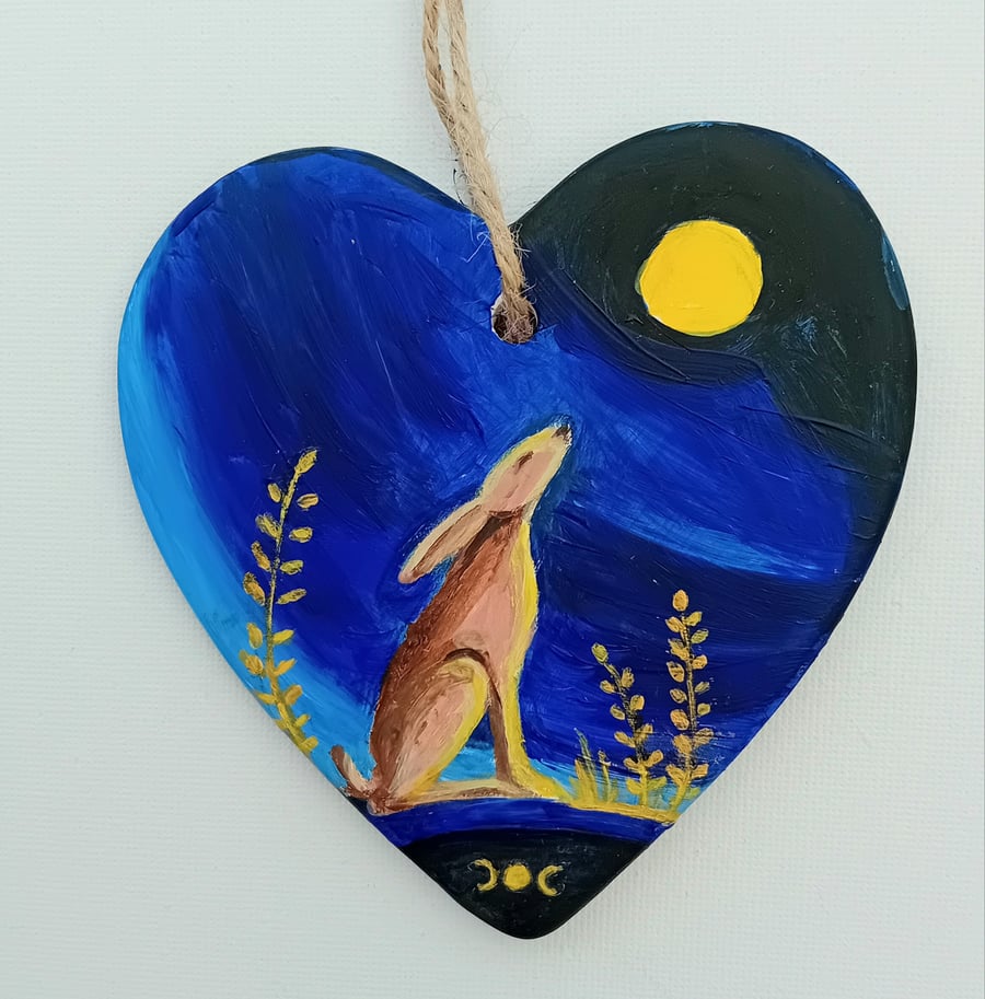 Moongazing hare on a ceramic heart shape 