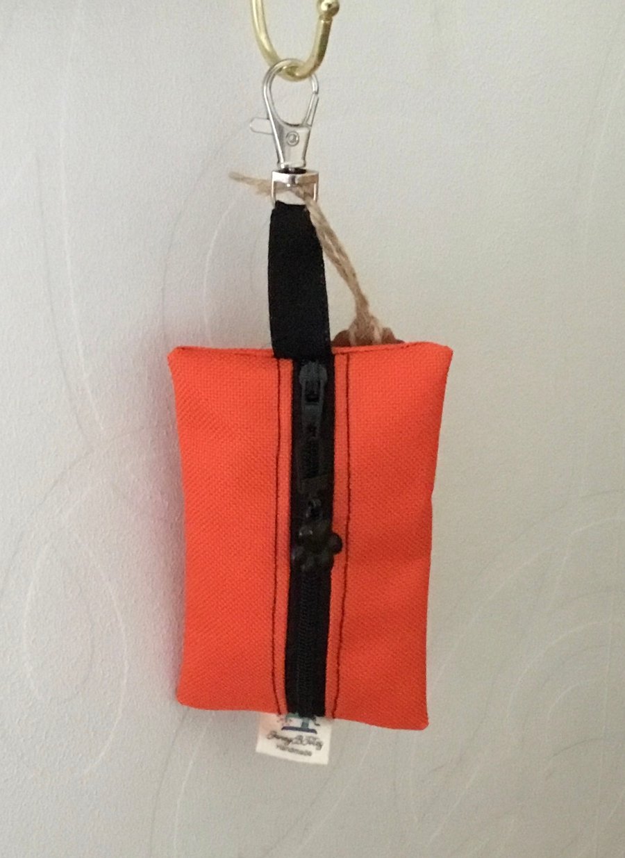 Orange dog bag carrier.