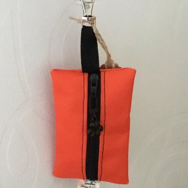 Orange dog bag carrier.