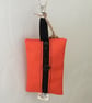 Orange dog bag carrier.