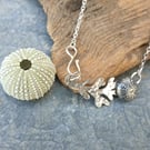 Silver sea urchin and seaweed pendant