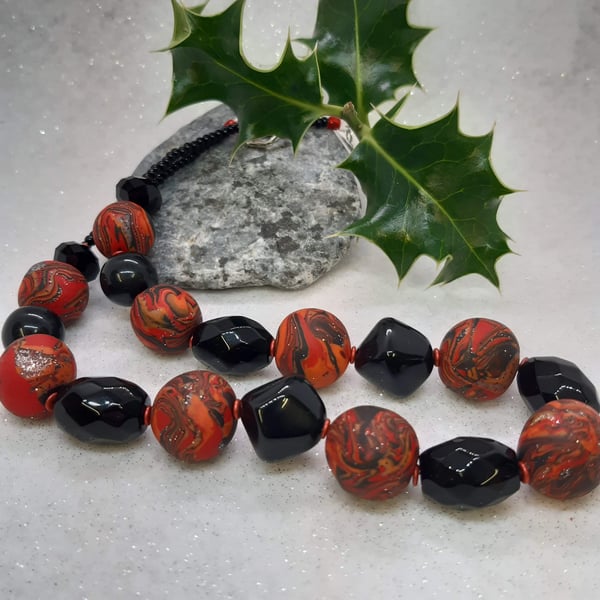 Necklace in  orange, red and black sparkle 