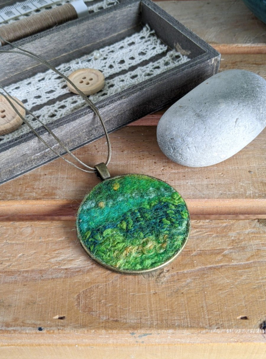 Felted pendant - greens, hint of yellow in a bronze bezel