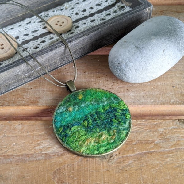 Felted pendant - greens, hint of yellow in a bronze bezel