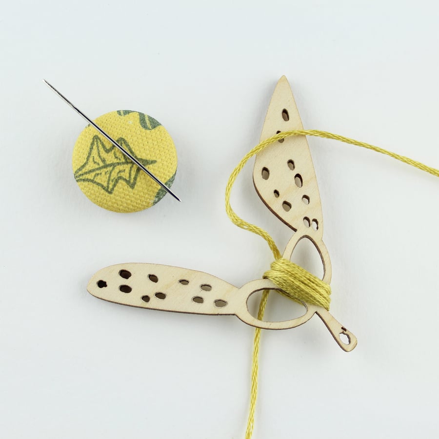 Seed head thread holder and magnetic needle minder