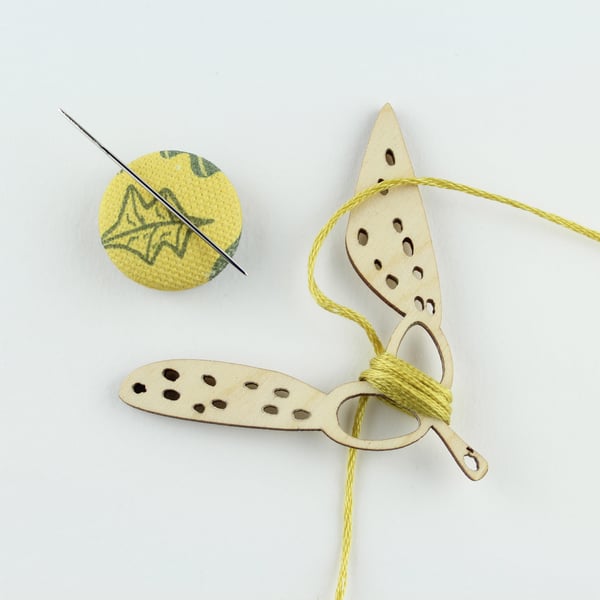 Seed head thread holder and magnetic needle minder