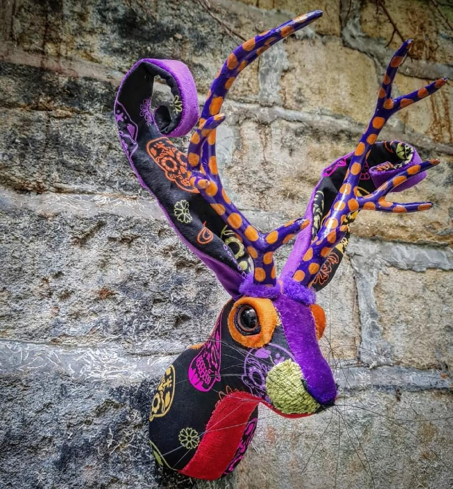 Faux jackalope head wall mount in Day of the Dead skull style fabric