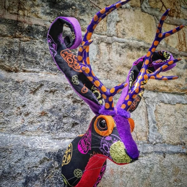 Faux jackalope head wall mount in Day of the Dead skull style fabric