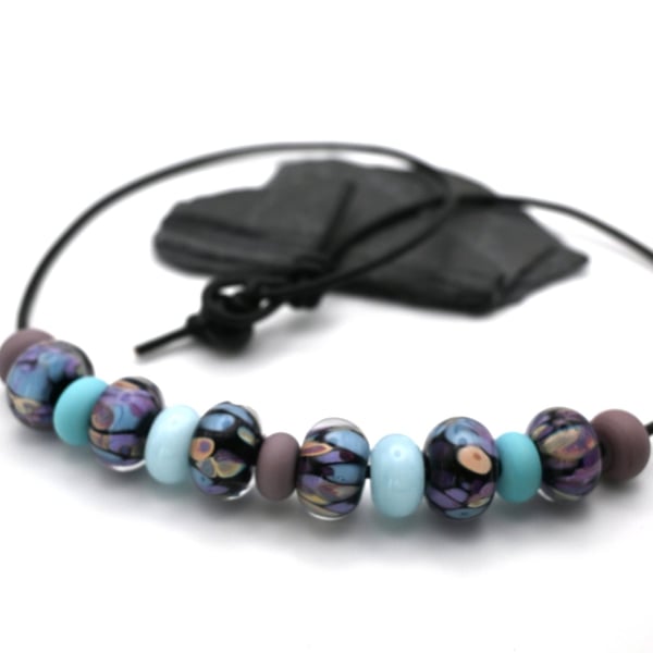 black, blue and purple lampwork glass leather cord necklace