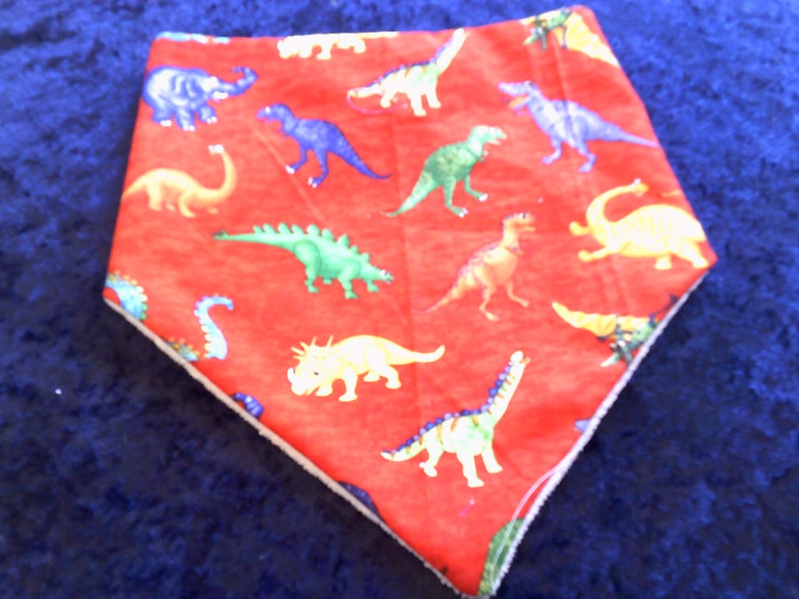 Brightly Coloured Dinosaurs on Red Dribble Bib