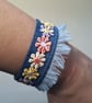 Upcycled Denim Cuff Bracelet with Pastel Floral Appliqué Ribbon - Free Postage - Image 1