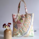 Little bucket bag padded in upcycled machined embroidery in a Folk art style