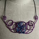 Purple twisted wire necklace.