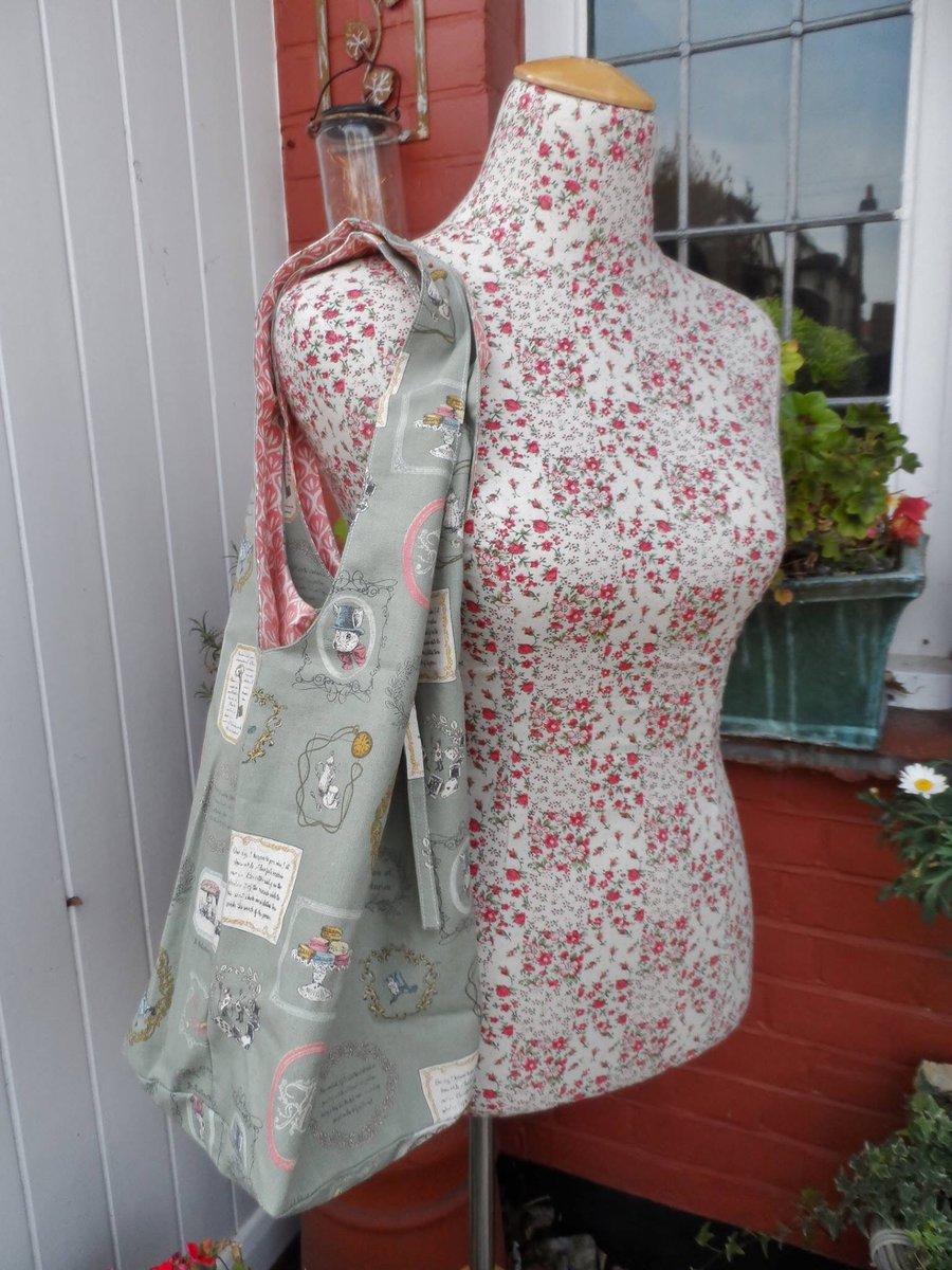 Shoulder slouch bag in an Alice in Wonderland themed print linen fabric.