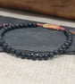 Men's black lava bead bracelet with adjustable hemp cord