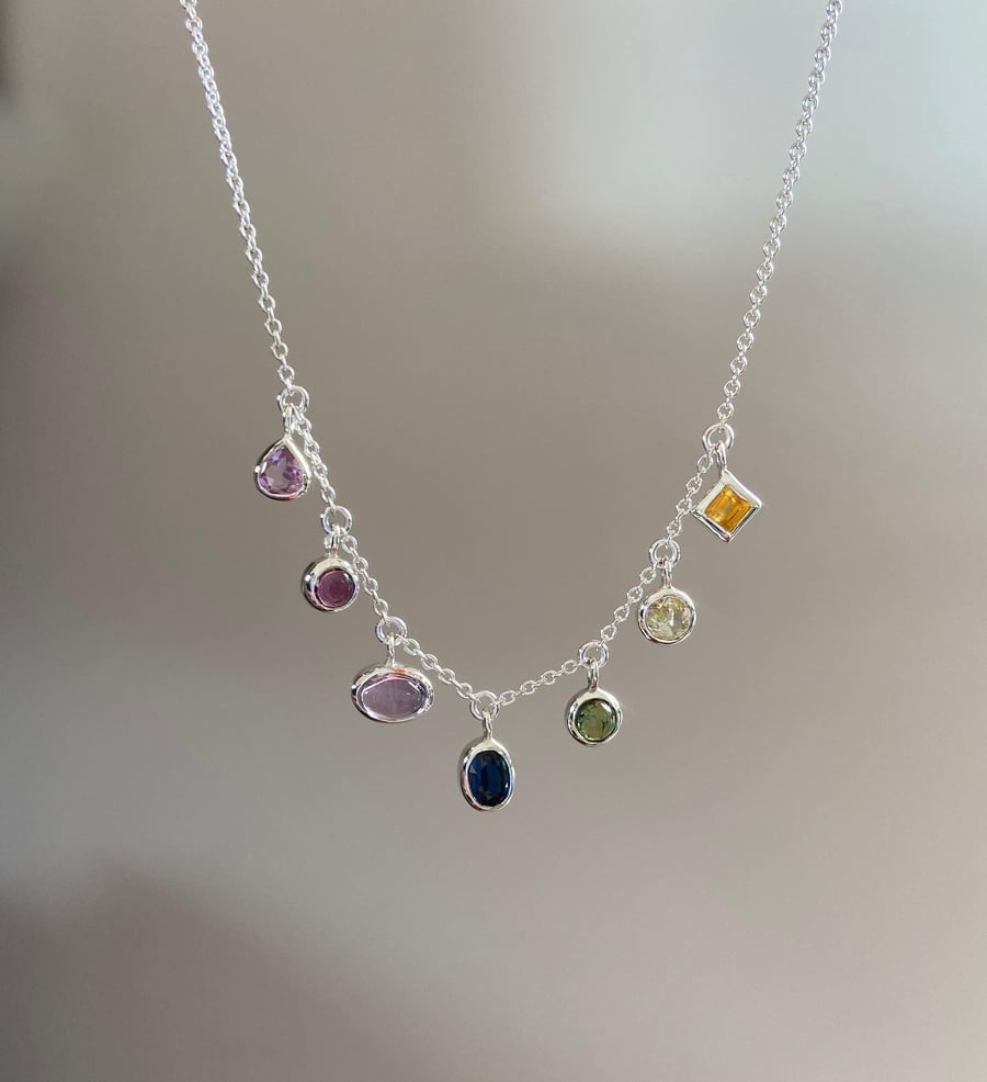 A rainbow pride necklace in tourmaline sapphire and amethyst LGBTQIA