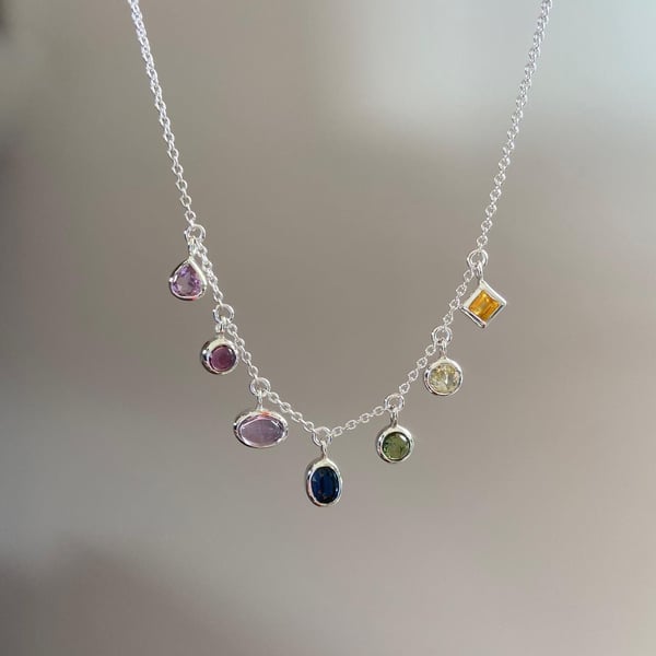 A rainbow pride necklace in tourmaline sapphire and amethyst LGBTQIA