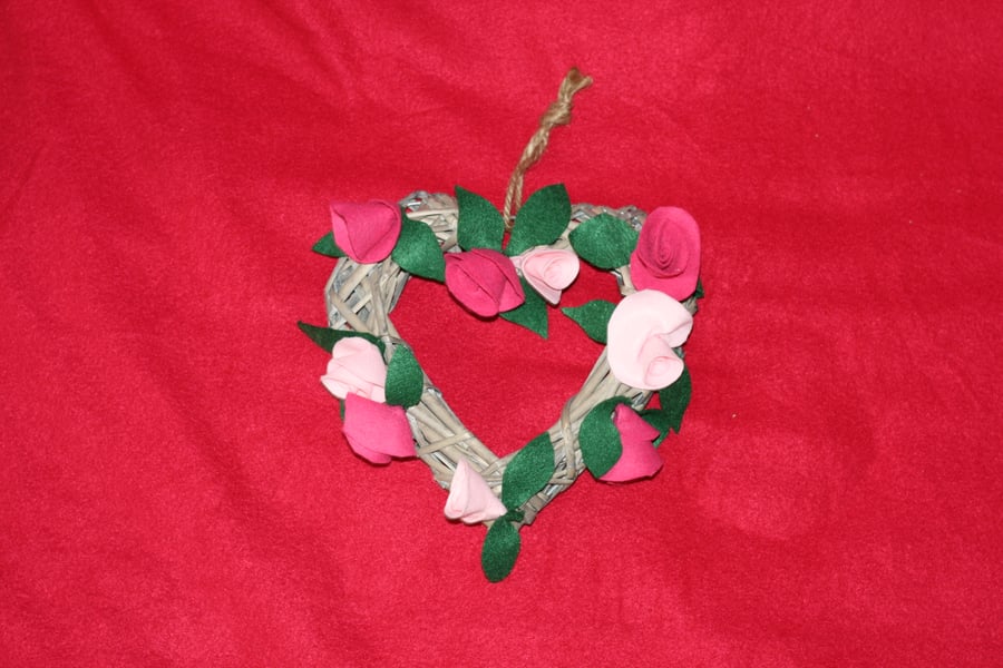 Wicker heart shaped wreath with pink roses