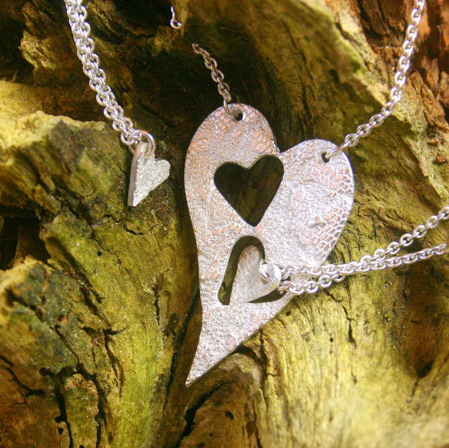 Three fine silver patterned heart pendants on sterling silver trace chains