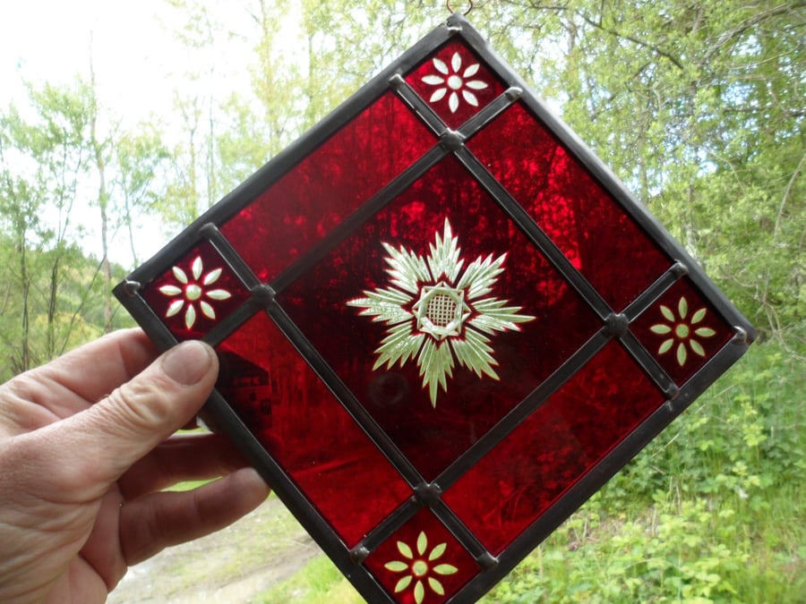 A red brilliant cut stained glass window mobile, suncatcher