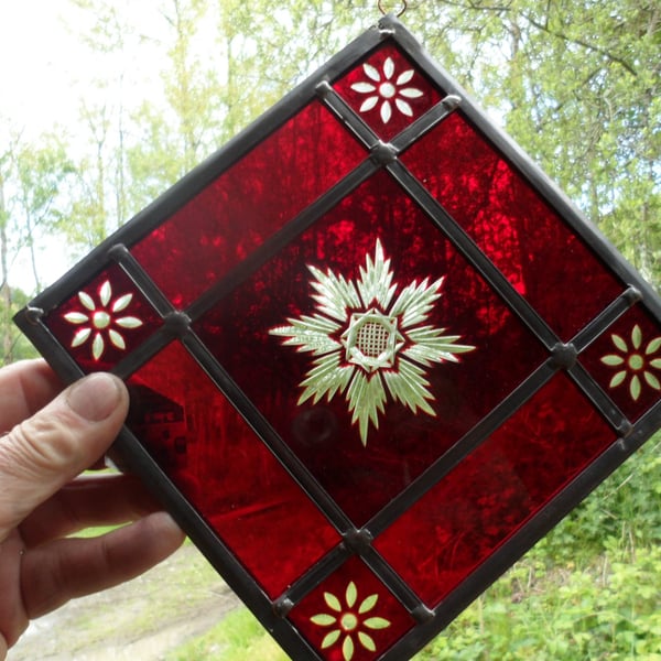 A red brilliant cut stained glass window mobile, suncatcher