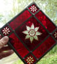 A red brilliant cut stained glass window mobile, suncatcher