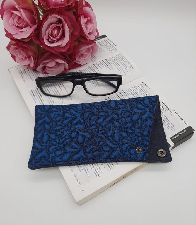 Teal and denim blue glasses sleeve with popper. 