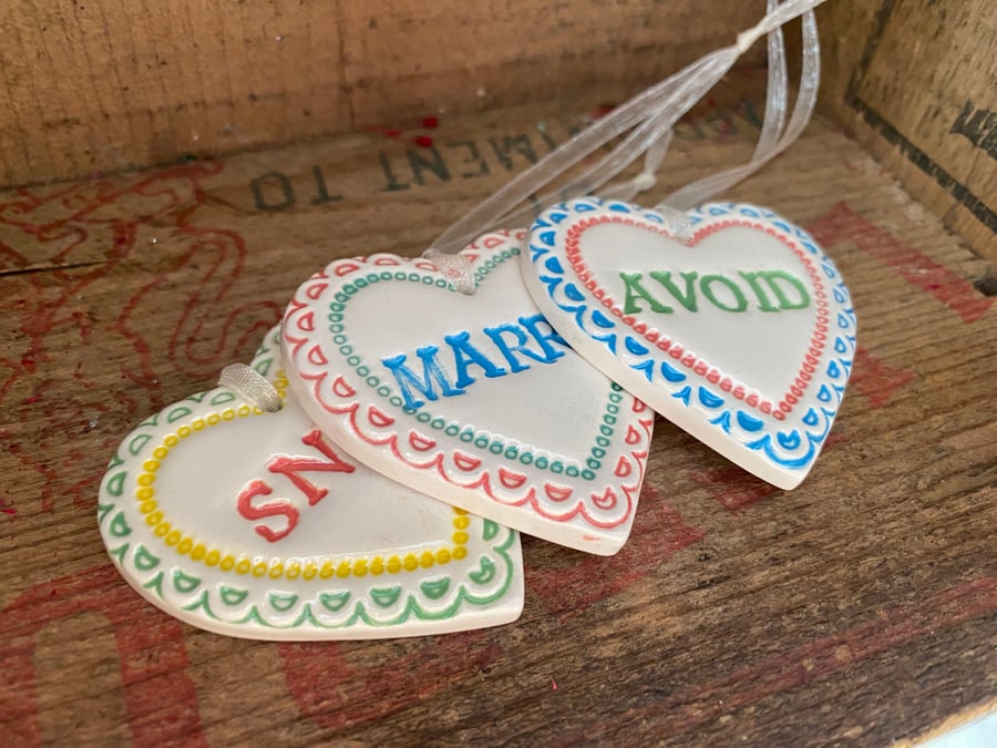 Set of pottery hearts. Snog, Marry, Avoid. Humour