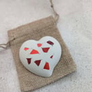 Handmade heart brooch crafted from smooth jesmonite and red aluminium pieces