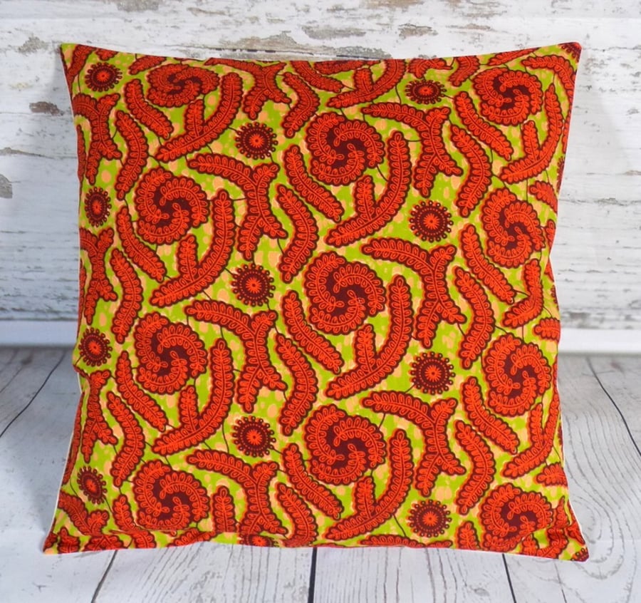 Cushion cover. African wax print, red on lime green and khaki