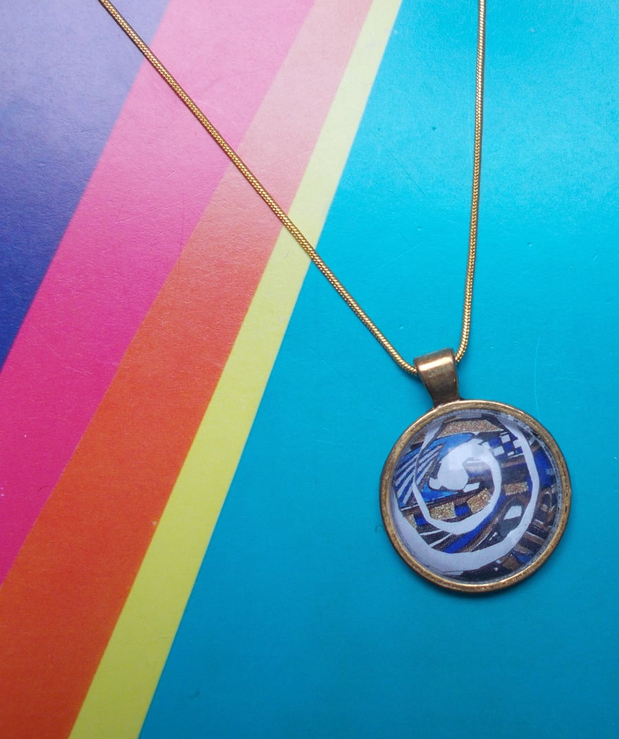 Gorgeous Blue Spiral in an Antique Gold Pendant