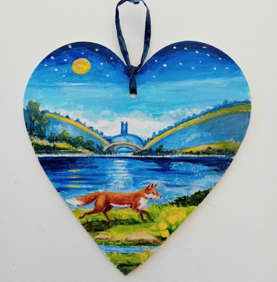 lakeside fox on a wooden heart  shape