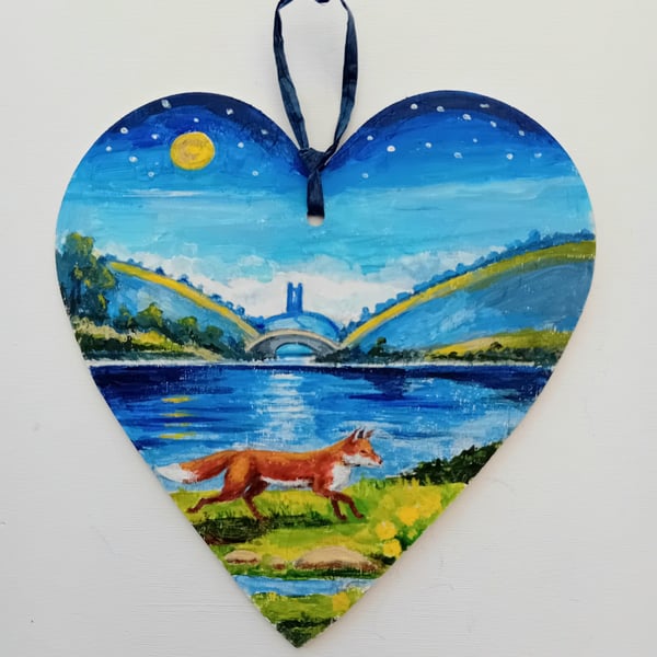lakeside fox on a wooden heart  shape