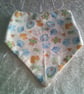 Babies Dribble Bib with Bottles, Bibs and Bootees in Blue on a Cream Background - Image 1
