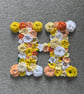 Initial H - hand made crochet flowers on plywood on back board