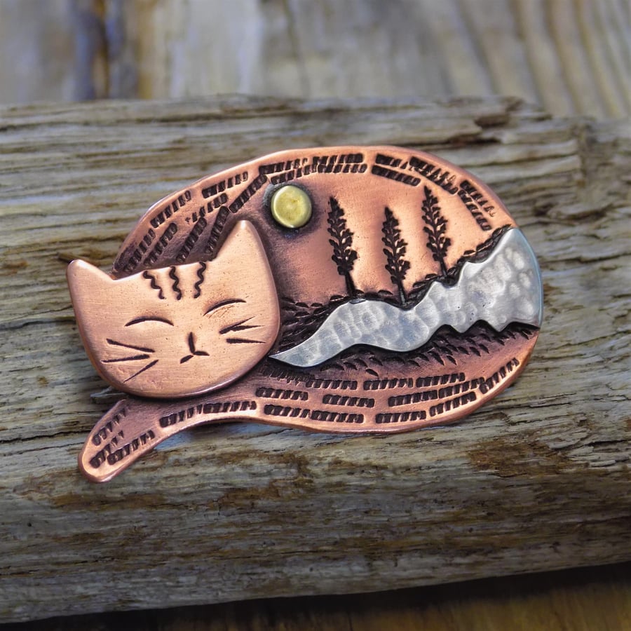 Copper, silver and brass 'sleeping cat ' landscape brooch
