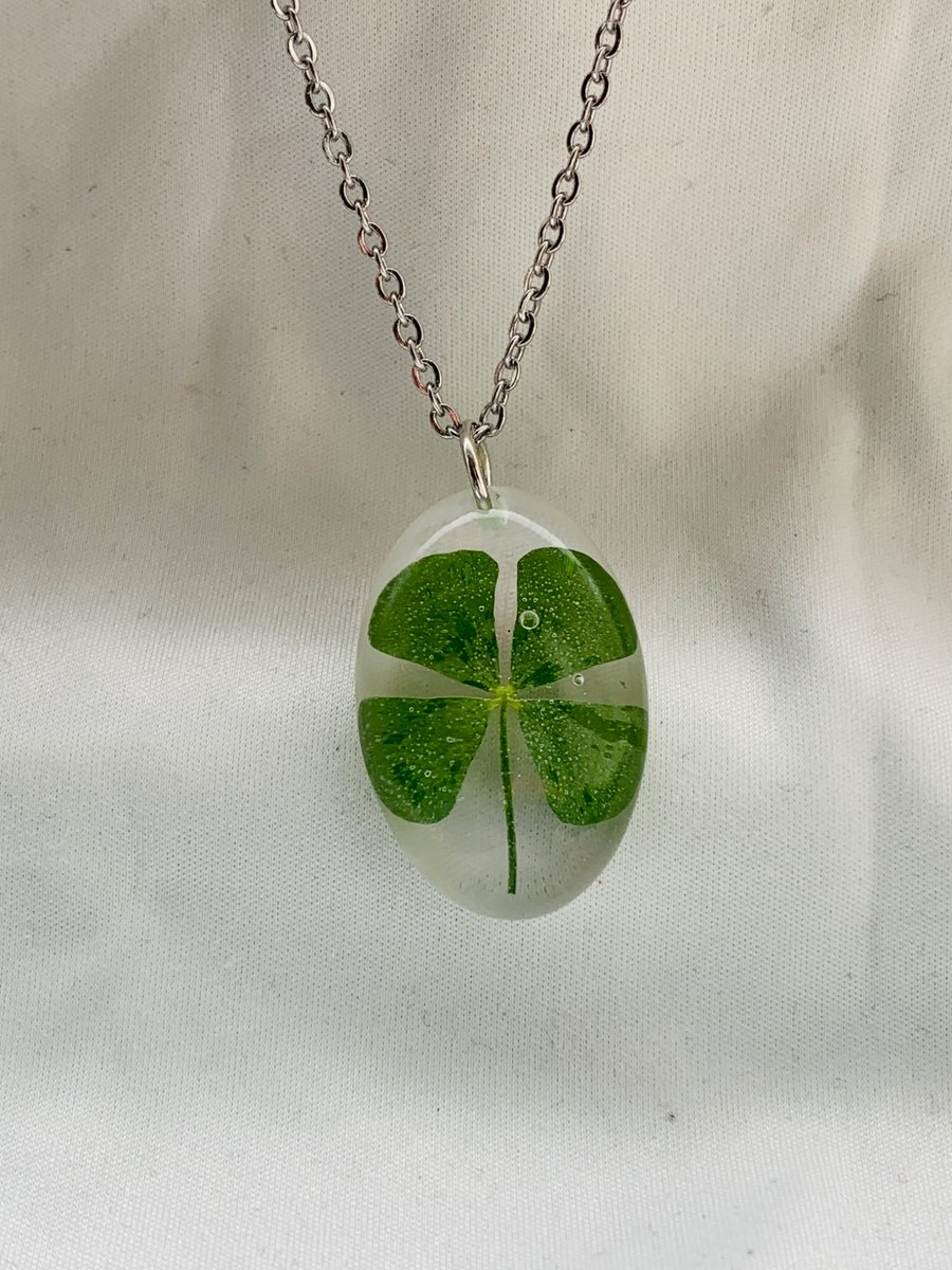 A beautiful handmade resin necklace a real 4 leaf clover