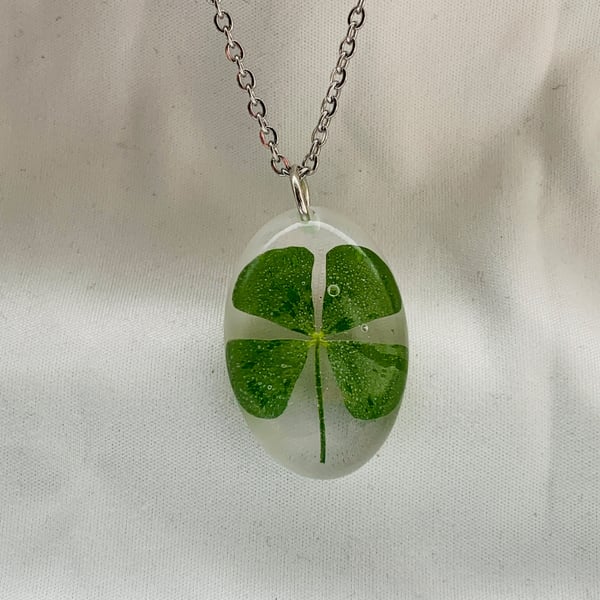 A beautiful handmade resin necklace a real 4 leaf clover