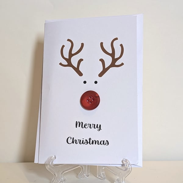 Merry Christmas card with a red nose button reindeer 
