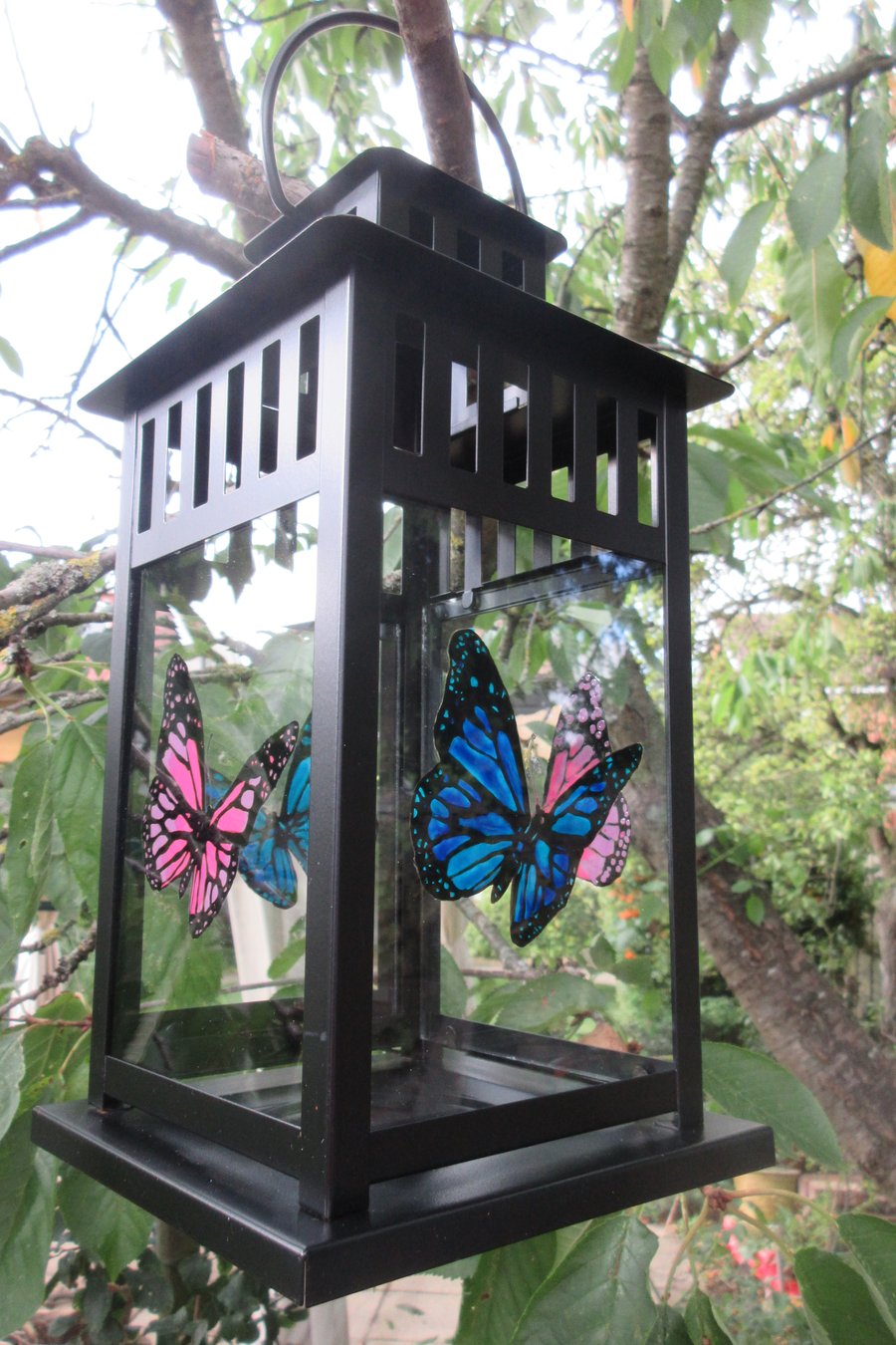 Lantern with hand painted pink and blue Butterflies on the glass panels 