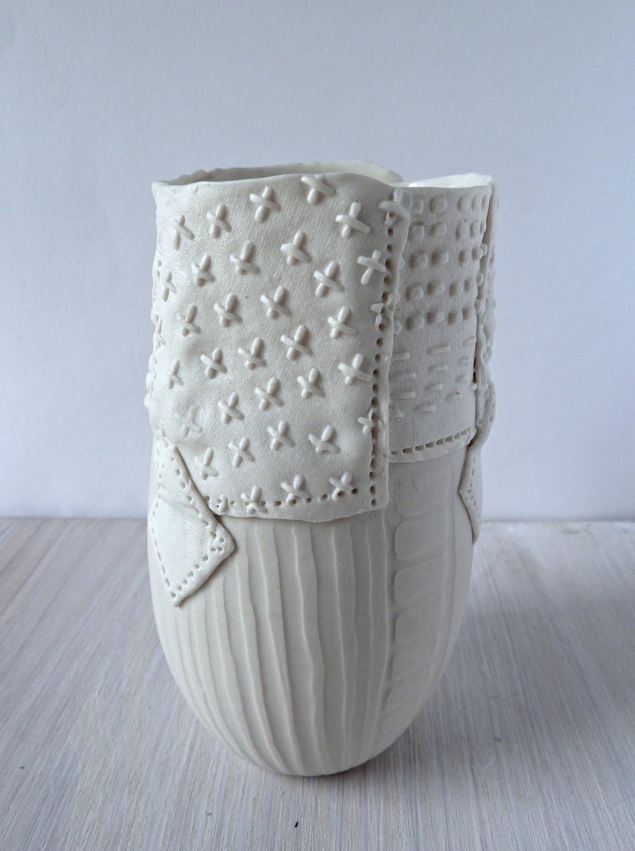 A delicate porcelain vase with impressed and resist decoration.